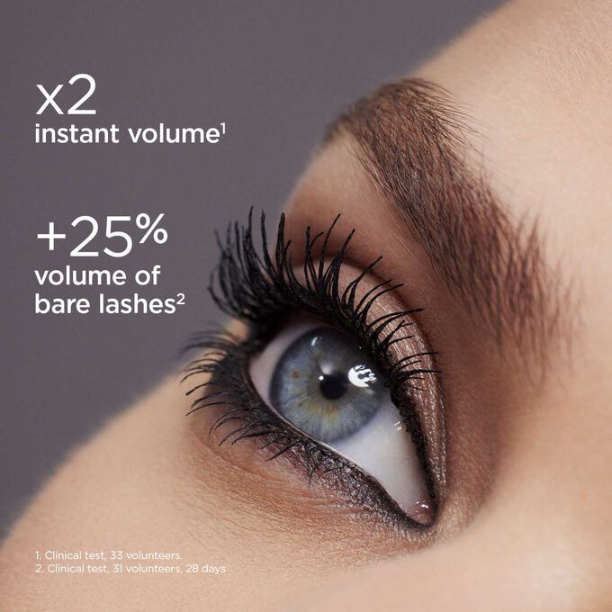 Close-up on a woman's blue eye wearing volume mascara to demonstrate the instant double volume effect