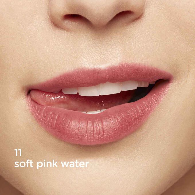 Close-up of smiling lips to showcase the texture and color of the rose lip stain on her skin tone